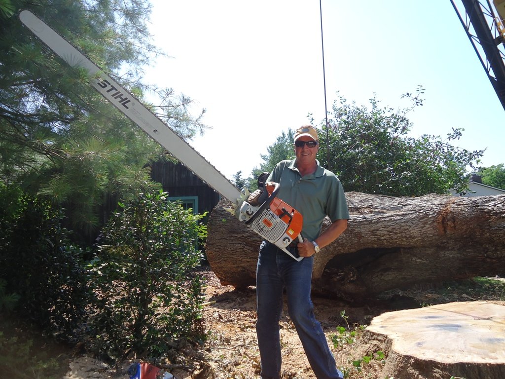 Man holding a large chain saw